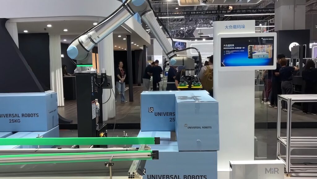 A UR20 cobot arm rom Universal Robots performing a palletizing demo at a tradeshow in China.